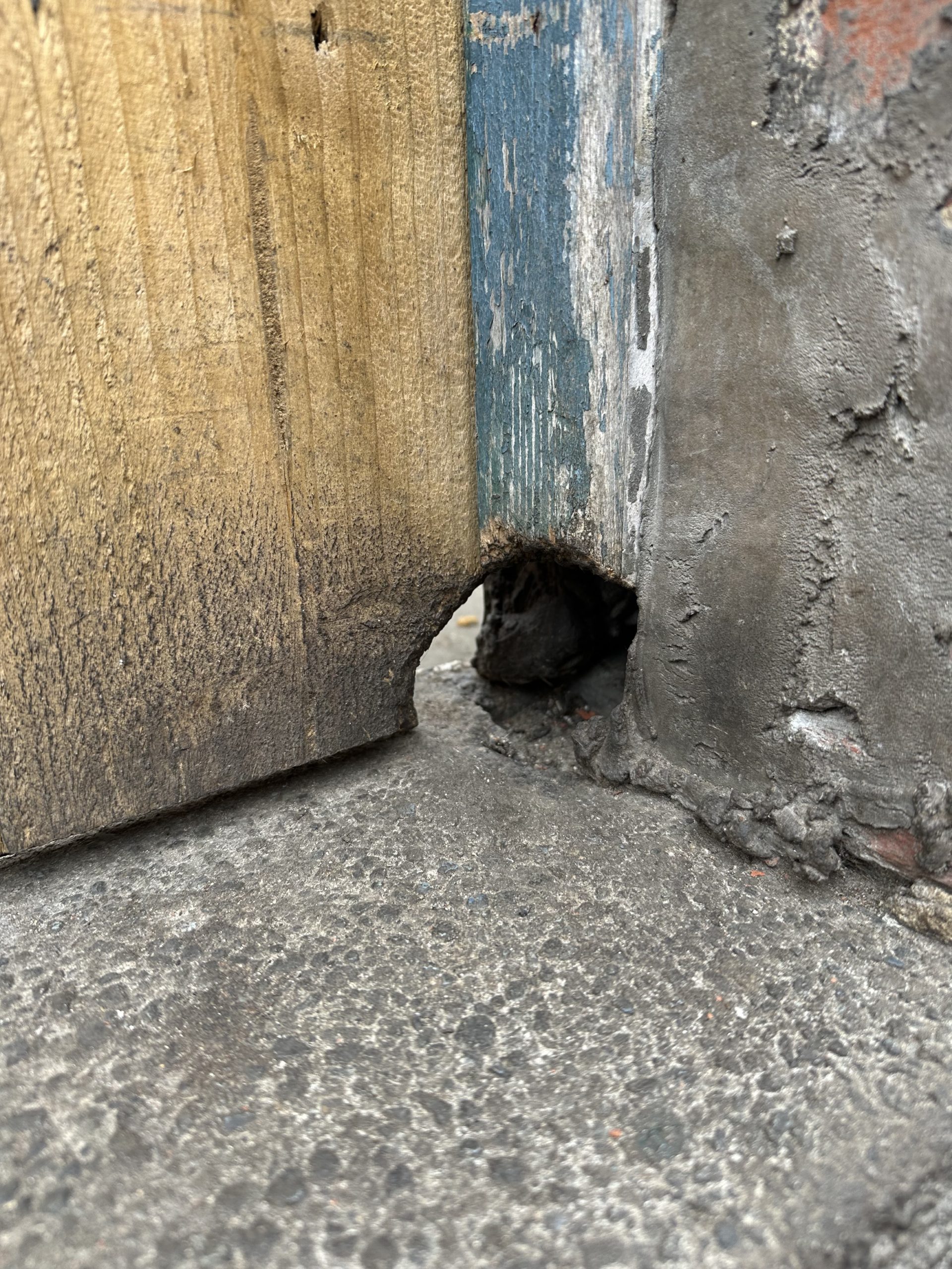 Small hole in wooden doorframe
